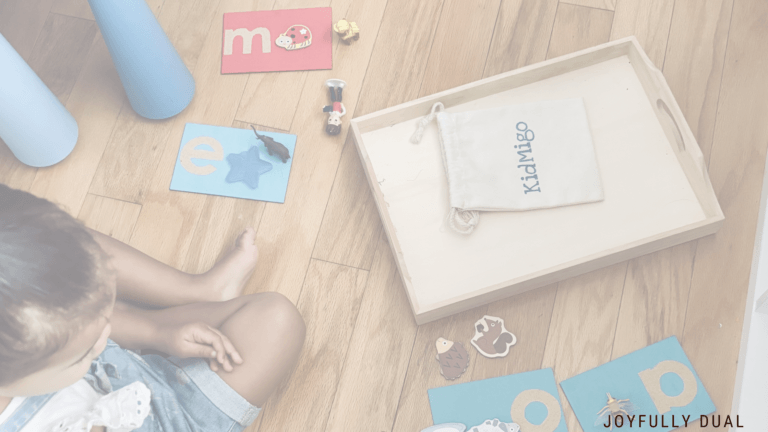 kid playing with letter sounds in spanish using sandpaper letters